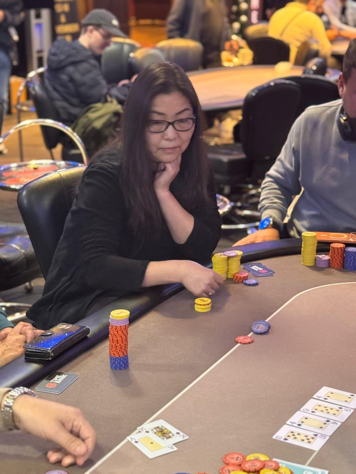BPS Ladies player gathering chips at the poker table