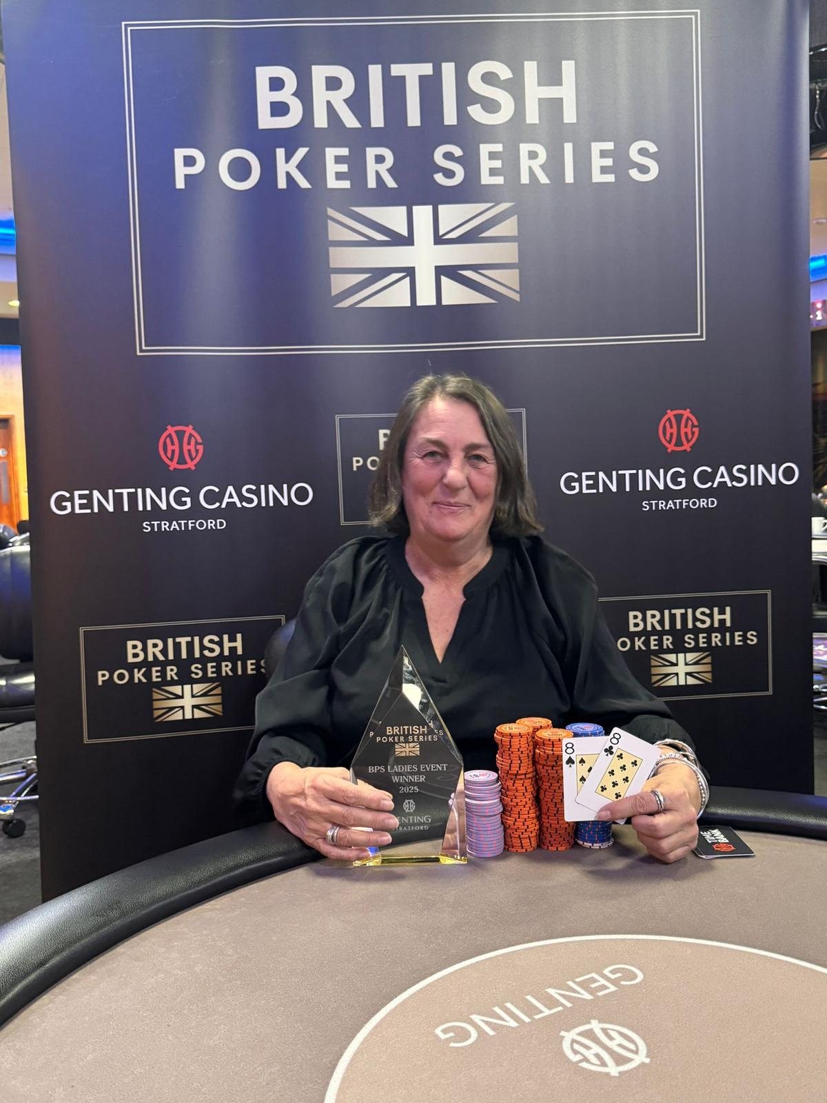 BPS Ladies event winner holding trophy, cards and chips
